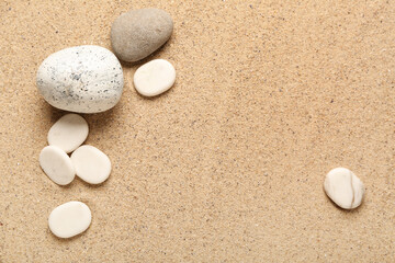 Different pebbles on beach sand