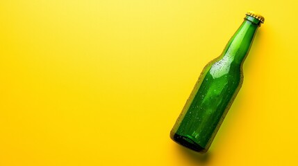 Fototapeta premium Green beer bottle on a yellow background with copy space