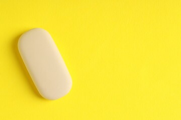 One eraser on yellow background, top view. Space for text