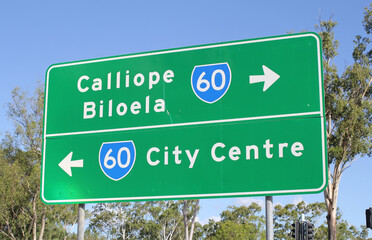 Green directional road sign pointing towards Calliope, Biloela and the City Centre in Gladstone,...