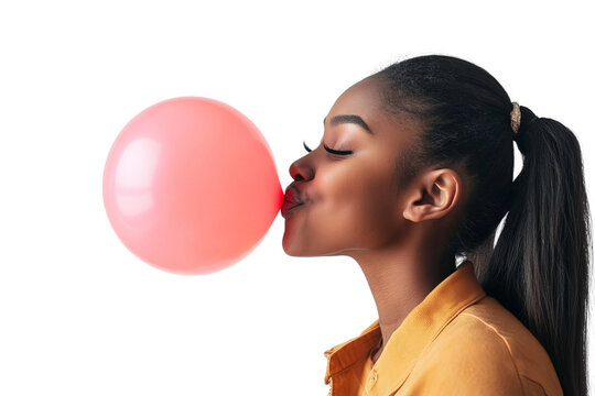a front view image of a 18 year old african american female leaning in and blowing up a ballon with her head turned in profile to one side, ponytail, happy, on a white background