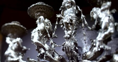 A slow pan reveals a chandelier in the Palma de Mallorca cathedral, highlighted by the selective focus of a tilt-shift lens - Powered by Adobe
