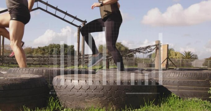People exercising on large tires with data processing animation overlay - Powered by Adobe