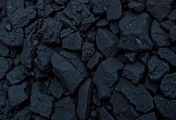 Fototapeta premium Black volcanic rock, close-up detail showing porous texture and rough surface, surface, obsidian
