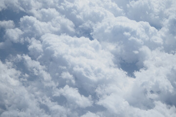 Bright white clouds fill the sky on a sunny day in summer