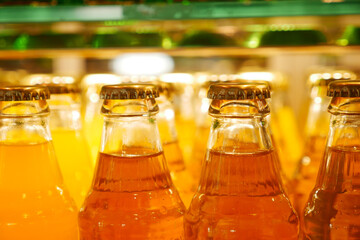 Bottles of colorful beverages displayed in a bright shop
