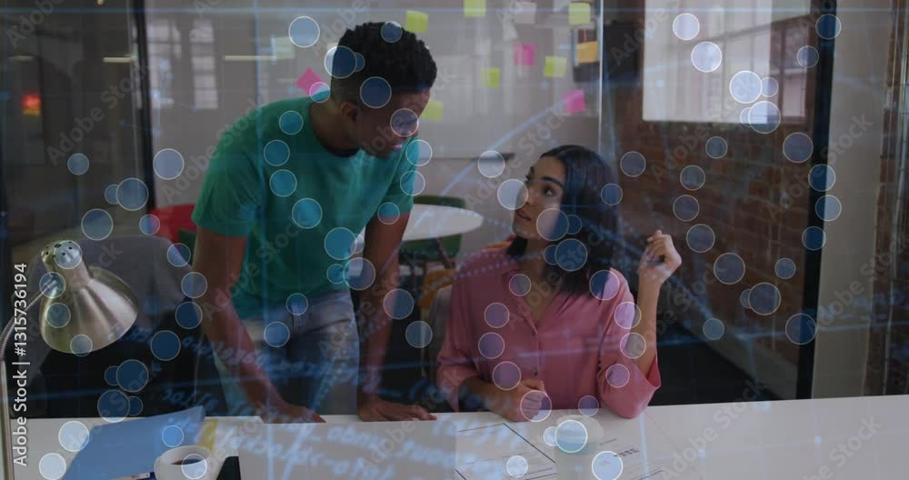 Poster discussing work at desk, two colleagues using animation with data visualization