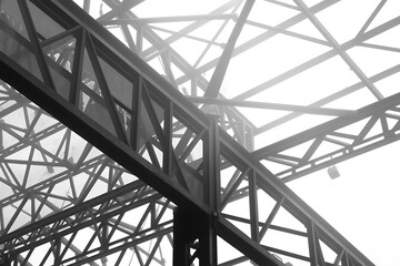 Complex Network Of Steel Beams Intertwines, Creating A Dense Structure Dissolving Into A Foggy, Monochrome Sky Above