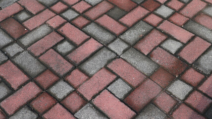 The texture of the paved tile on the bottom of the street. Cement brick squared stone floor background. Concrete paving slabs.