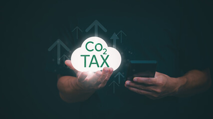 Ideas for reducing carbon emissions Businessman showing carbon tax collection graph and environmental conservation, green business, sustainable environmental development.