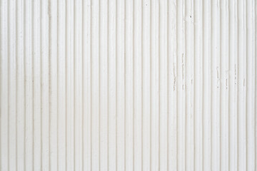 A white wavy wall with a copy space for your design. Decorative plaster on the wall. Uneven wall surface. High quality photo