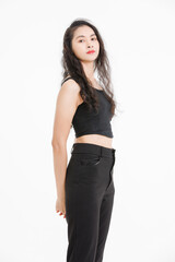 Portrait of asian beautiful woman with curly hair, wearing black tank top black long pants, model girl attractive confident cheerful standing smiling pose look at camera on white background in studio.
