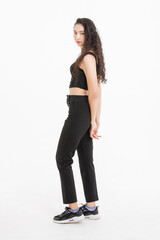 Portrait of full body asian beautiful woman with curly hair, wearing black tank top black long pants, model girl attractive confident standing smiling pose look at camera on white background in studio