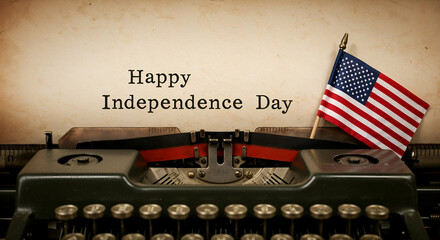 Vintage Typewriter's Patriotic Message: A vintage typewriter, with a classic design, proudly displays a message of "Happy Independence Day", complemented by a miniature American flag.