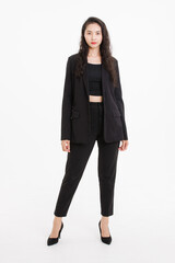 Fototapeta premium Portrait full body of asian beautiful woman curly long hair, wearing black suit, black long pants, model girl attractive confident charming, standing pose look at camera on white background in studio.