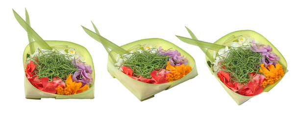 Balinese daily offerings, canang sari is made from young coconut leaves and decorated with colorful flowers and other elements.