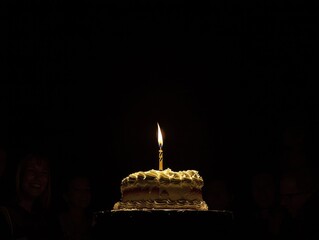 Glowing birthday cake with single candle and happy faces in the background, celebrations