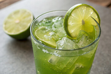  Green colour drink or cocktail, lime splash and ice cubes in glass