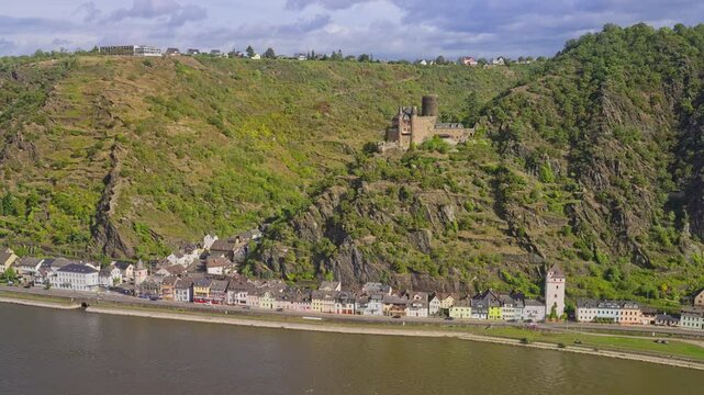 Panoramic aerial view over the small town of Sankt Goarshausen near Sankt Goar, with steep cliffs and natural landscape on a sunny day, Rhine Valley, Germany