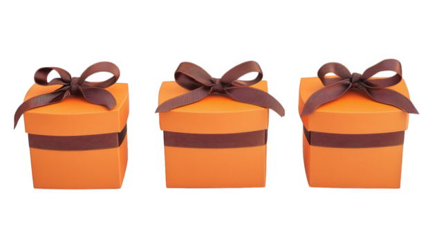 three small orange gift boxes with brown ribbons arranged neatly they symbolize celebration gifting and special occasions