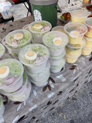 Vendor selling cuisine at street bazaar in Malaysia catered for iftar during Muslim fasting month of Ramadan