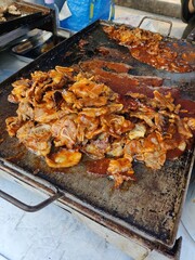 Vendor selling cuisine at street bazaar in Malaysia catered for iftar during Muslim fasting month of Ramadan