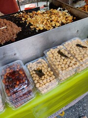 Vendor selling cuisine at street bazaar in Malaysia catered for iftar during Muslim fasting month of Ramadan