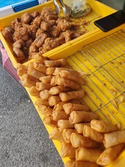 Vendor selling cuisine at street bazaar in Malaysia catered for iftar during Muslim fasting month of Ramadan