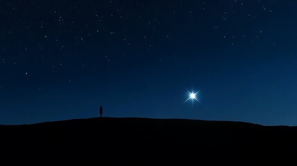 Naklejka premium Solitary figure silhouetted against a starlit night sky, a bright star shining.