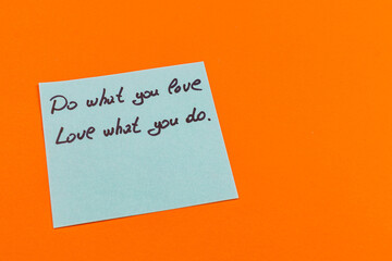 Handwritten note on blue paper encourages passion and dedication in work
