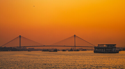 Sunset golden hour image of Ganges river along with Vidyasagar Setu bridge
