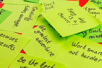 Encouraging sticky notes spread across a vibrant surface for daily motivation