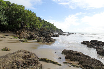 Obraz premium Etty Bay beach with the ocean, sand, trees and rocks in Far North Queensland, Australia