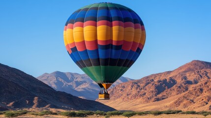 A vibrant hot air balloon floats above a sprawling desert landscape under a clear blue sky, evoking a sense of adventure and freedom.
