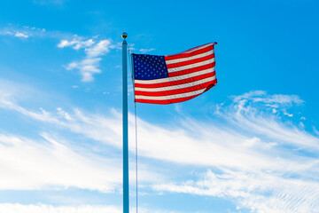 Flag of the USA. National waving flag of united states on blue sky. Independence day. Patriotic symbol. American Flag for Memorial Day or 4th of July. American flag. Day of independence
