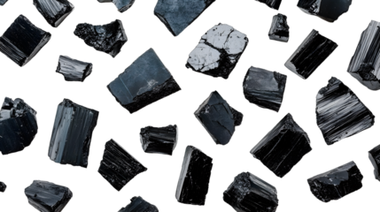 Close-up of coal pieces and fragments arranged on white minimalist design emphasizing fossil fuel and raw material visuals