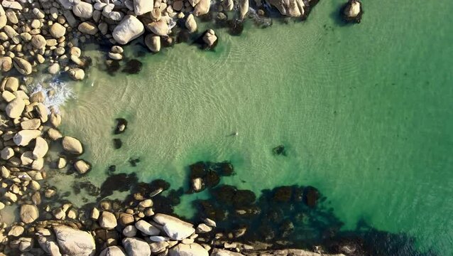 Aerial drone video from above fairy cove in Wilson's Promontory in Victoria. Drone ascends slowly revealing surrounding rocks and foliage