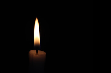 Close-up of a candle in the dark	
