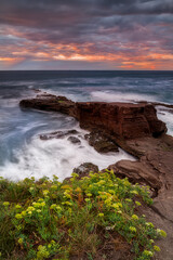 Sunset with a sky with dramatic clouds on the beach of Tunelboca on the cliffs of La Galea, Getxo, Bizkaia