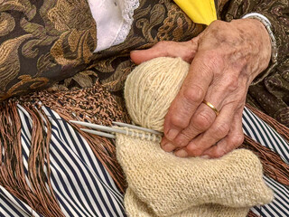 hands of senior woman knitting