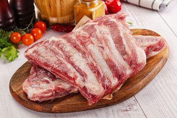 Raw pork ribs over board