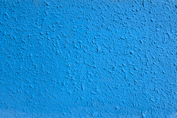 Close-up of a vibrant blue textured wall with rough surface details, ideal for backgrounds, design elements, or architectural concepts.