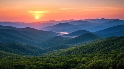 Fototapeta premium Stunning sunrise over rolling hills and mountains, showcasing layers of blue and green hues.