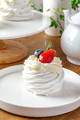 meringue cakes with cream and berries