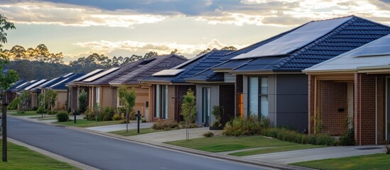 Obraz premium Suburban street with solar panel equipped houses at sunset.