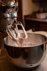 Fluffy strawberry marshmallow clings to beaters after whipping