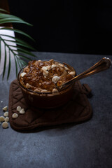 High-protein red velvet baked oats with white chocolate and a spoon