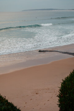 Footprints in the sand leading to the ocean in Baleal, Portugal