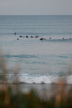 Group of surfers waiting in the ocean in Baleal, Portugal