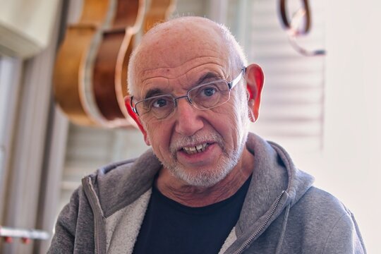 Portrait of a violin maker in his workshop.